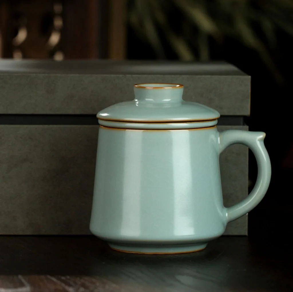 Pale celadon tea mug with matching lid and crackle glaze