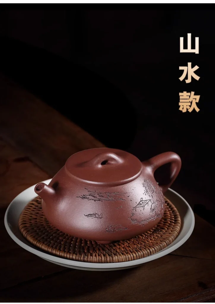 Landscape decoration and lid of the Zini teapot shown on a tea tray